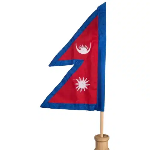 Close-up of an embroidered Nepal table flag on a polished wooden stand, ideal for desk decor or gift